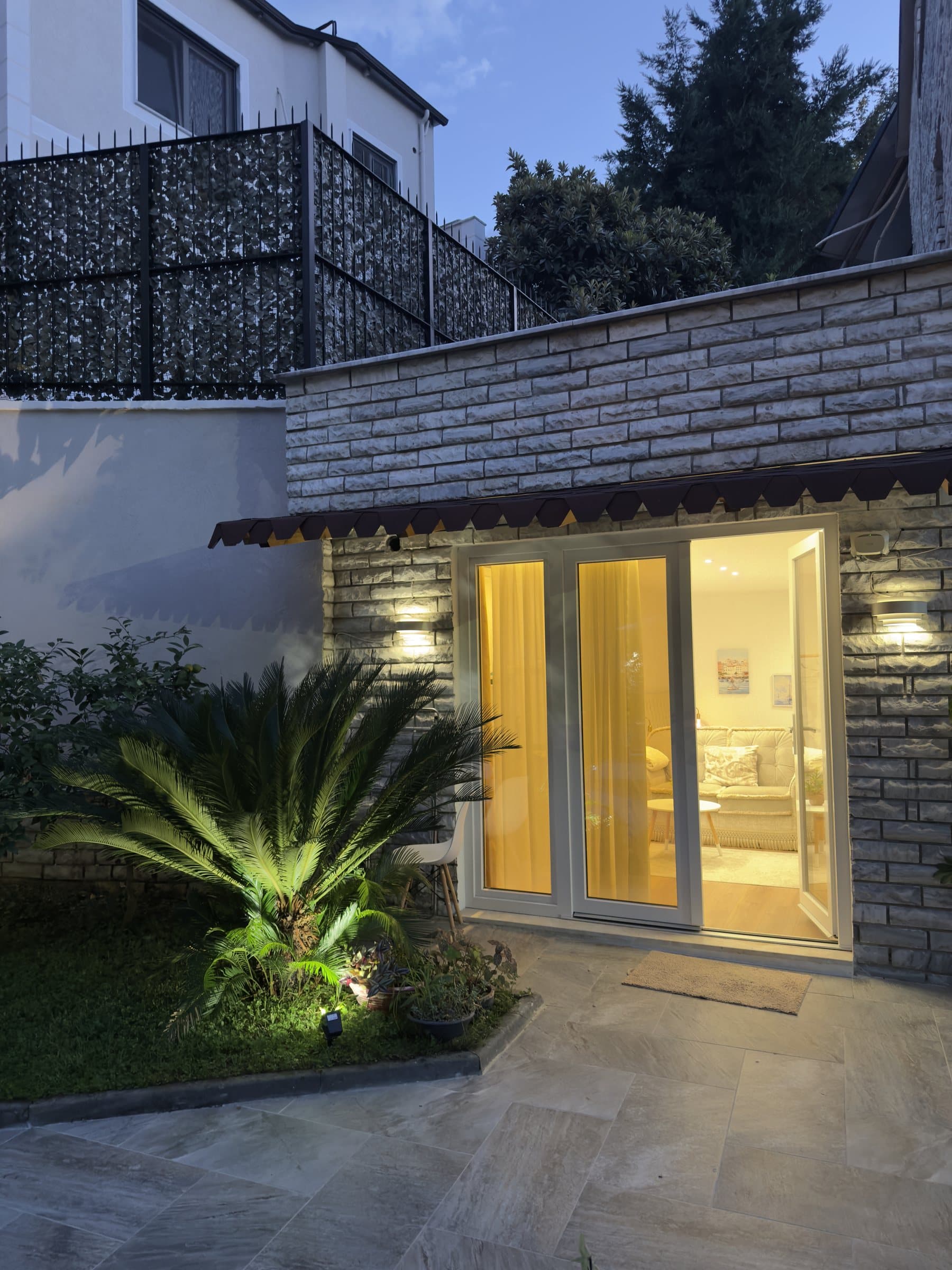 The stone studio on your left