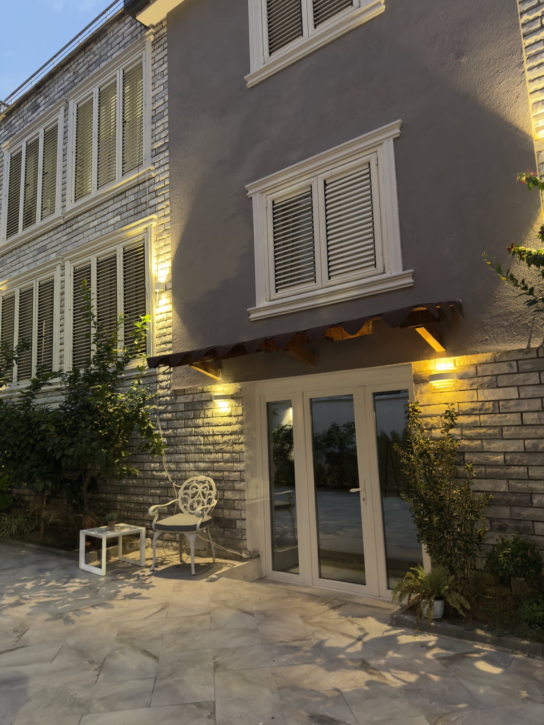 Across the courtyard to the lit doors
